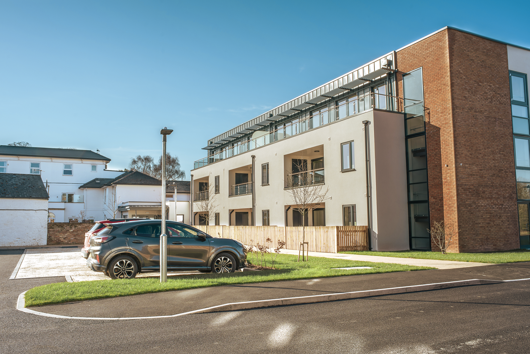 Apartment building and gravel parking at Albion Meadows.