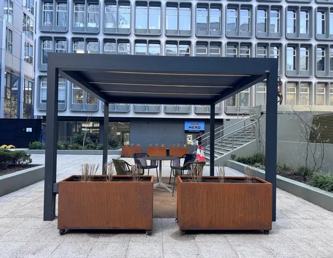 Corten planters beside sheltered seating at Riverside.